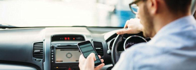 man using cell phone in car